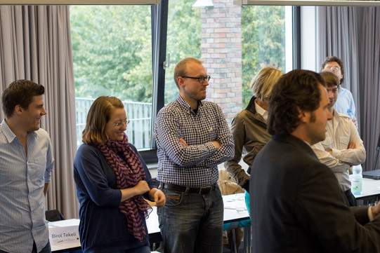 Participants listen to a lecture standing up