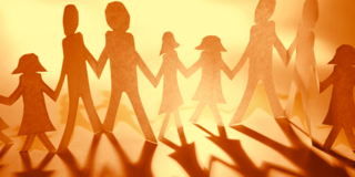 Stylized paper cutout figures of a family holding hands