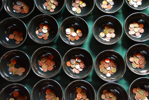 Small bowls are shown, which are filled with coins.