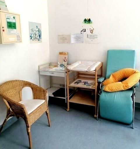 In one corner there is a changing table and also a nursing chair