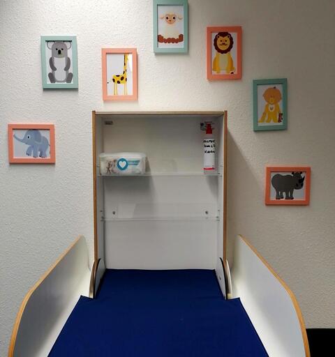 Folded changing table on the wall