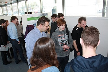 Participants look at a poster